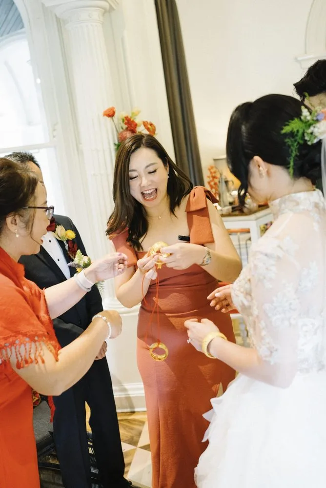 Bridesmaid presenting gold jewellery during a Chinese wedding ceremony hosted by Jenny Chiu in Melbourne